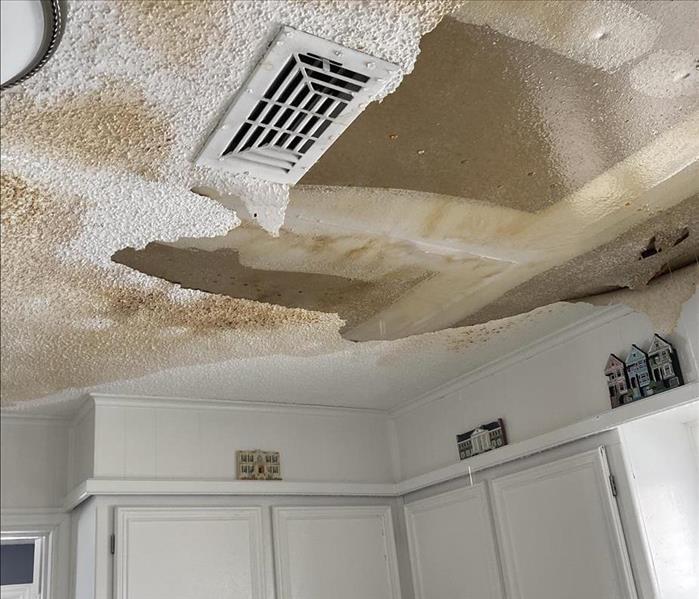 Damage to a kitchen ceiling due to a burst pipe. 